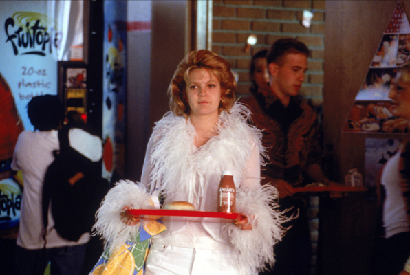 Still from cafeteria scene in film NEVER BEEN KISSED, of protagonist Julia dressed in outrageous clothes, wondering with whom she should sit at lunch.